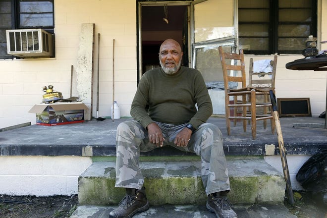 In this photo taken Nov. 27, Larry Lamb poses for a photo while taking a break from painting at his brother's home in Mount Olive.