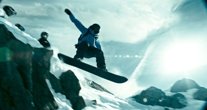 Sheer-face snowboarding is one of the newfangled sports in “Point Break.” (Warner Bros.)