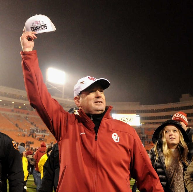 FILE - In this Nov. 28, 2015, file photo, Oklahoma head coach Bob Stoops holds up a Big 12 Champions hat following a 58-23 win over Oklahoma State in an NCAA college football game in Stillwater, Okla. The Sooners wisely stuck with Stoops as their head coach, even when many in this what-have-you-done-for-me-lately world questioned whether he was the guy to lead them back to the promised land. Now, the Sooners are Big 12 Conference champions and two wins away from a national championship. (AP Photo/Brody Schmidt, File)