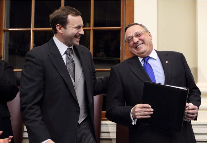 In this February 2013 file photo, Republican Gov. Paul LePage, right, accepts a pat on the back from Democratic Speaker of the House Mark Eves before delivering his State of the State address at the State House in Augusta, Maine. The governor's intervention to get Eves fired from his job at a charter school roiled the Statehouse, led to a lawsuit and cast a cloud over the upcoming legislative session. The drama that pitted LePage against Eves was voted top story of the year by The Associated Press and its member affiliates in Maine. AP Photo/Robert F. Bukaty, File
