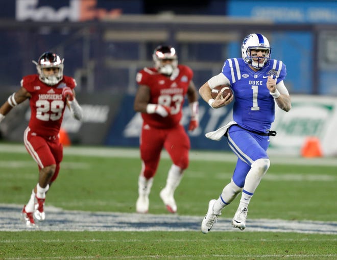 Duke quarterback Thomas Sirk, right, runs the ball for a touchdown during Duke's 44-41 win over Indiana in the Pinstripe Bowl at Yankee Stadium in New York on Saturday. Associated Press