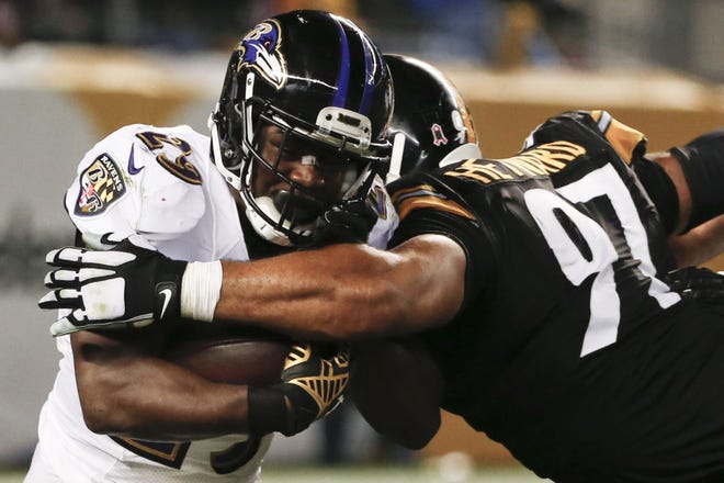 Ravens running back Justin Forsett, left, is hit by Steelers defensive end Cameron Heyward  as he runs the ball during the Ravens' 23-20 overtime win on Oct. 1, in Pittsburgh. Forsett had 150 yards rushing in the win.
