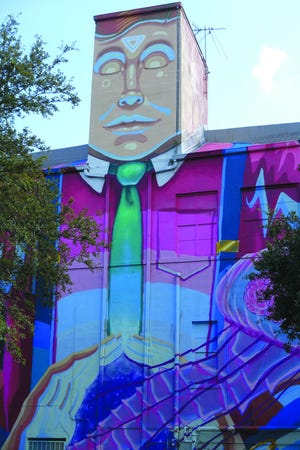 A mural by Derek Donnelly and Sebastian Coolidge transforms the Florida Craft Art building in St. Petersburg, Fla., into a man.