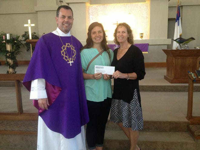 Grace Lutheran Pastor Kevin Wendt and Cindy Theriault present at grant to Anna Keipert of Clarkston Student Ministries in Georgia.