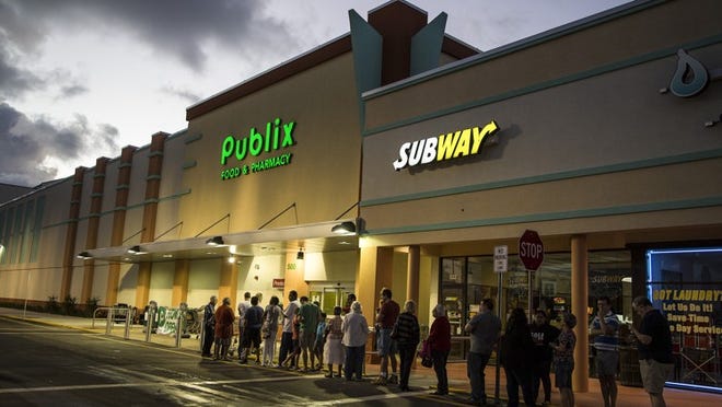 People line up for the 7 a.m. opening of the new Publix opens in the Belmart Plaza at 500 Belvedere Road in West Palm Beach, December 12, 2015. (Greg Lovett / The Palm Beach Post)