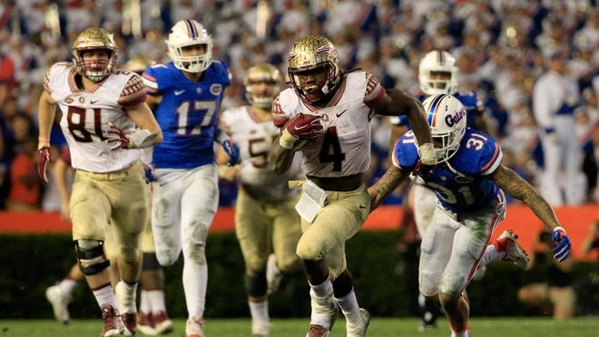 GAINESVILLE, FL - NOVEMBER 28: Dalvin Cook #4 of the Florida State Seminoles runs for yardage during the game against the Florida Gators at Ben Hill Griffin Stadium on November 28, 2015 in Gainesville, Florida. (Photo by Sam Greenwood/Getty Images)