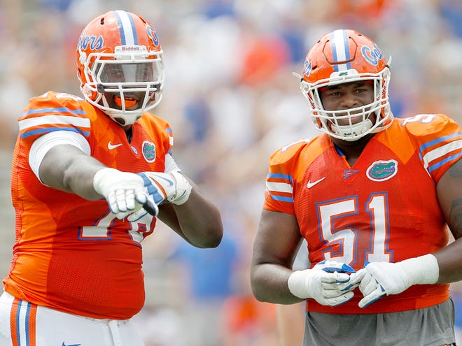 In this April 11, 2015 file photo, Florida Gators offensive lineman David Sharpe, left, talks with Antonio Riles, Jr. between plays during second half of the Orange & Blue Debut at Ben Hill Griffin Stadium in Gainesville. Sharpe is taking a leadership role with younger players on the offensive line.
,
