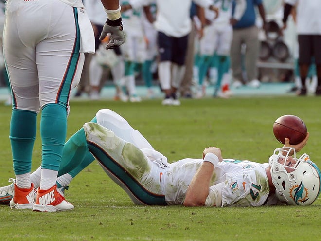 Miami Dolphins quarterback Ryan Tannehill lies on the field after a sack during the final seconds of the second half of an NFL football game against the Indianapolis Colts, Sunday, Dec. 27, 2015, in Miami Gardens. The Colts defeated the Dolphins 18-12.