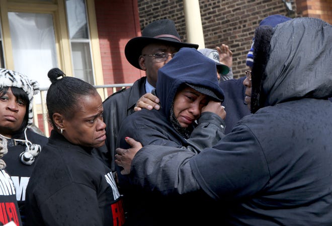 Janet Cooksey, center, the mother of Quintonio LeGrier, is comforted by family and friends during a news conference to speak out about Saturday's shooting death of her son by the Chicago police, on Sunday, Dec. 27, 2015, in Chicago. Grieving relatives and friends of two people shot and killed by Chicago police said Sunday that the city's law enforcement officers had failed its residents.