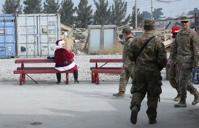 A U.S. soldier dressed as Santa Claus waves to fellow troops on Christmas day at the U.S. air base in Bagram, north of Kabul, Afghanistan. The Associated Press