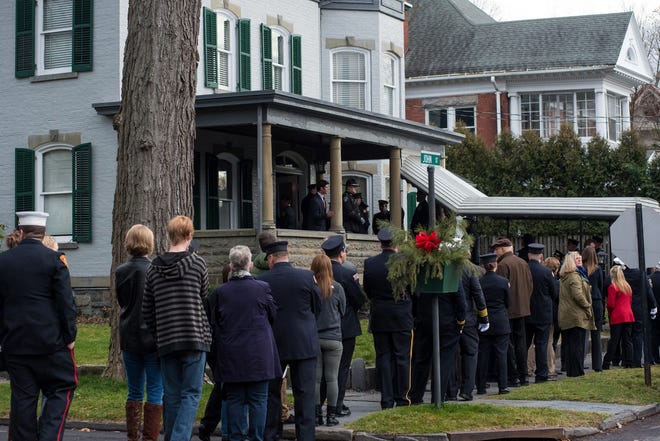People wait outside the Seamon-Wilsey Funeral Home to attend the wake of Jack Rose in Saugerties on Sunday. KELLY MARSH/FOR THE TIMES HERALD-RECORD