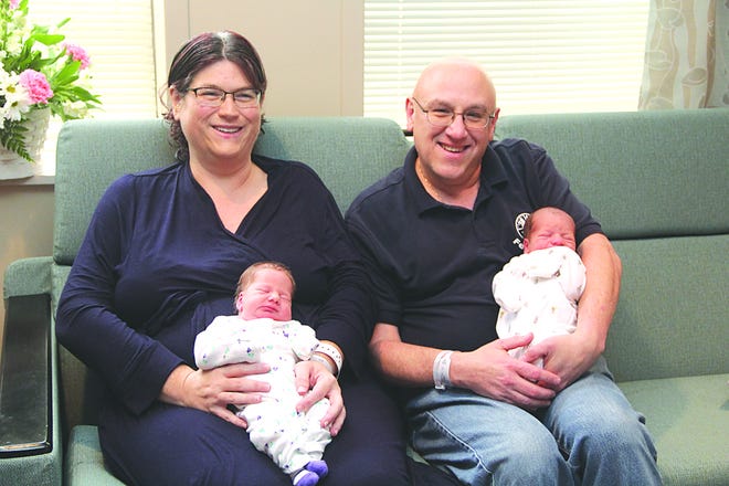 Angela and Gary Summers hold newborn twins Harper and Austin.