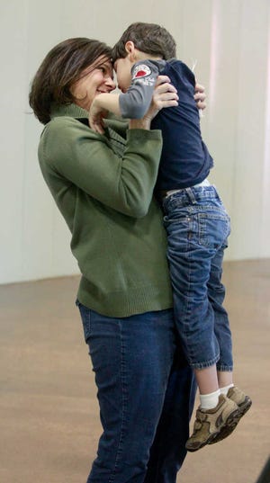 Jill Ramsey holds her 6-year-old son Benner Ramsey to calm him.