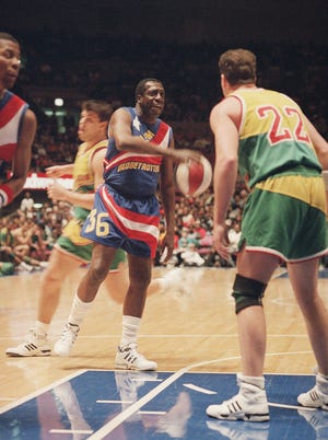 In this file photo, legendary Harlem Globetrotter Meadowlark Lemon prepares to put the moves on Washington Generals Tim Burkhart during their game on Saturday, Feb.13,1993, at New York's Madison Square Garden in New York.