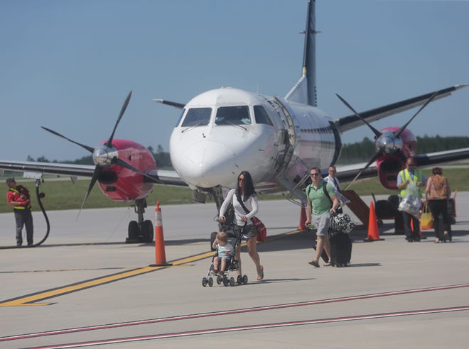 Passengers exit a Silver Airways flight on the tarmac at Northwest Florida Beaches International Airport.