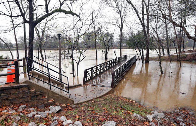 A part of the Riverwalk is closed off due to the rising Black Warrior River Monday, Dec. 28, 2015. Heavy rain ceased by the afternoon and temperatures cooled off. More rain is possible Tuesday night into Wednesday according to the National Weather Service.