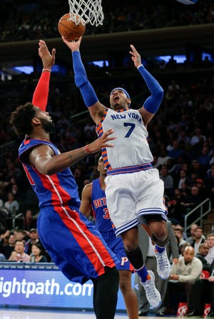 New York Knicks' Carmelo Anthony (7) shoots over Detroit Pistons' Andre Drummond (0) during the second half of an NBA basketball game Tuesday, Dec. 29, 2015, in New York. The Knicks won 108-96. (AP Photo/Frank Franklin II)