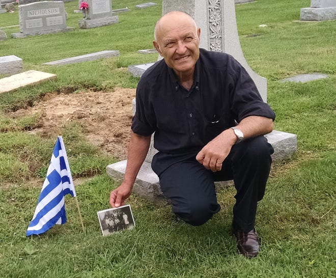Costas Afentakis marks his great grandfather's, Stratos Psareas', grave at Appomattox Cemetery with a small Greek flag and a family photo. Psareas came to Hopewell 105 years prior to Affentakis finding his gravesite.