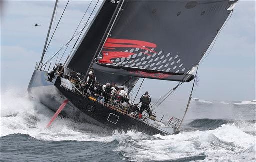 Skippered by Newport's Ken Read, Comanche sails out of the heads during the start of the Sydney Hobart yacht race in Sydney Saturday.