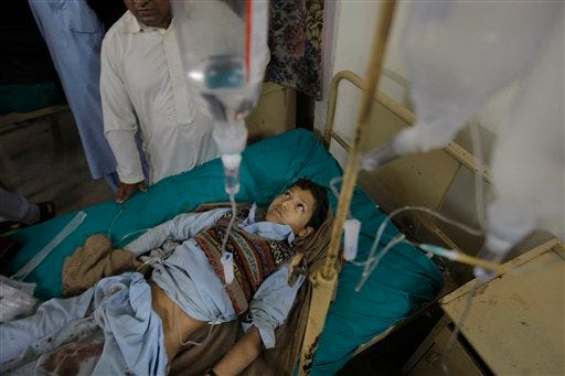 A Pakistani child injured in a suicide attack admits at a local hospital in Mardan, Pakistan, Tuesday, Dec. 29, 2015. A suicide bomber blew himself up outside a government office in a northwestern Pakistani city on Tuesday, killing more than a dozen people and wounding tens. A breakaway Taliban group quickly claimed responsibility for the attack. (AP Photo/Mohammad Sajjad)