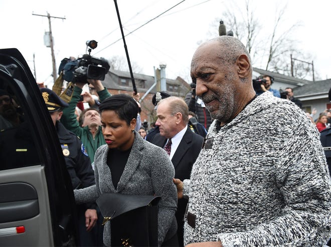 Bill Cosby is led to a waiting car after his arraignment flanked by attorneys Monique Pressley and Brian J. McMonagle on Wednesday, Dec. 30, 2015, at the office of District Judge Elizabeth McHugh in Elkins Park. Cosby was then taken to the Cheltenham Police Department for booking.