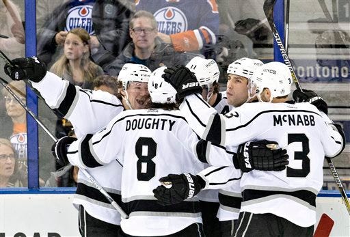 Los Angeles Kings' Tyler Toffoli (73), Drew Doughty (8), Milan Lucic (17) and Brayden McNabb (3) celebrate a goal against the Edmonton Oilers during the second period of an NHL hockey game in Edmonton, Alberta, Tuesday, Dec. 29, 2015. (Janson Franson/The Canadian Press via AP) MANDATORY CREDIT