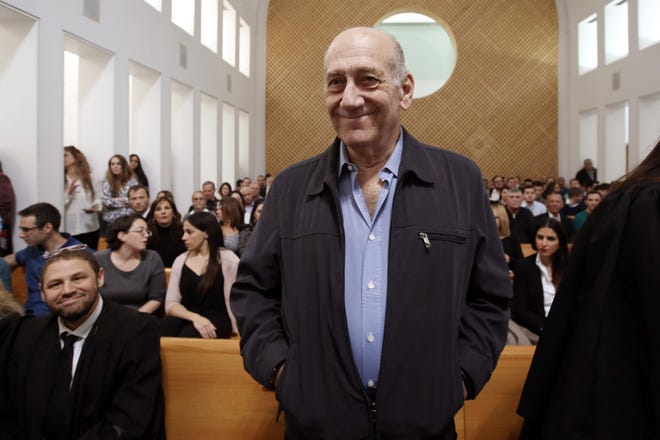Former Israeli prime minister Ehud Olmert is seen in the court room as he waits for the judges at the Supreme Court in Jerusalem on on Tuesday, Dec. 29, 2015. Israel's Supreme Court reduced Olmert's prison sentence for a sweeping bribery scandal from six years to 18 months, partially accepting his appeal and clearing the ex-premier of the main bribery charge against him. (Gali Tibbon/Pool Photo via AP)