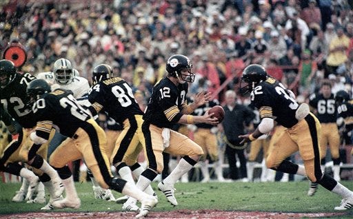 FILE - In this Jan. 21, 2015, file photo, Pittsburgh Steelers quarterback Terry Bradshaw (12) turns around to hand the ball off to running back Franco Harris (32) during Super Bowl XIII NFL football game action against the Dallas Cowboys in Miami. Bradshaw, voted the game's most valuable player, completed 17 of 30 passes for 318 yards, breaking Bart Starr's record of 250 yards passing by halftime. (AP Photo/File)