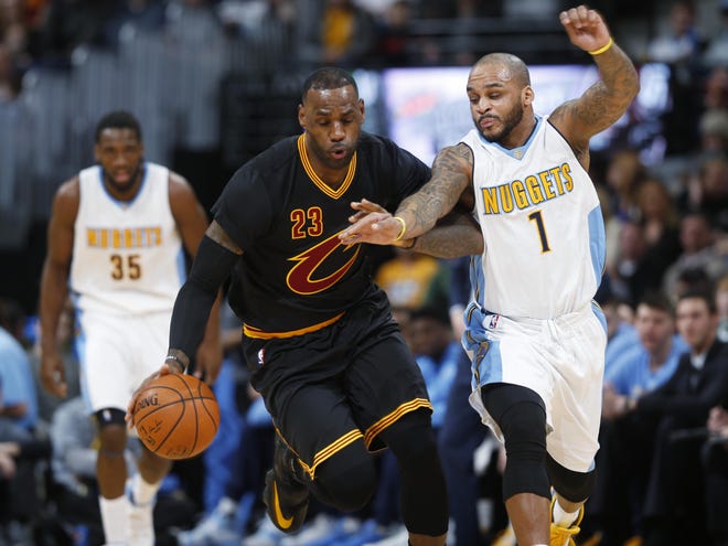 Denver Nuggets guard Jameer Nelson, right, fouls Cleveland Cavaliers forward LeBron James as they pursue the ball during the first half of an NBA basketball game Tuesday, Dec. 29, 2015, in Denver. (AP Photo/David Zalubowski)