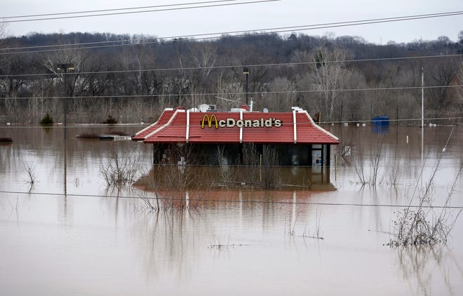 Floodwater from the Bourbeuse River surrounds a McDonald's restaurant, Tuesday, Dec. 29, 2015, in Union, Mo. Torrential rains over the past several days pushed already swollen rivers and streams to virtually unheard-of heights in parts of Missouri and Illinois. (AP Photo/Jeff Roberson)