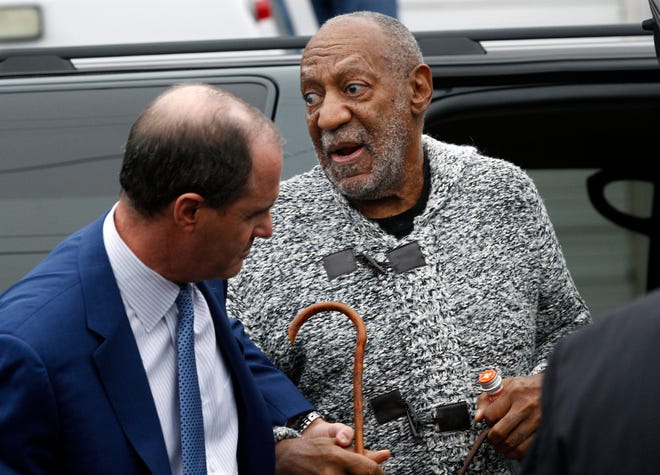 Actor and comedian Bill Cosby is helped as he arrives for a court appearance to face a felony charge of aggravated indecent assault on Wednesday in Elkins Park, Pa. Cosby was arrested and charged Wednesday with drugging and sexually assaulting a woman at his home 12 years ago. AP Photo/Mel Evans