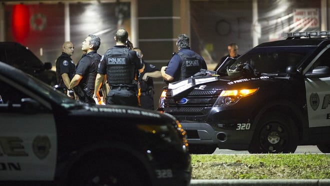 Boca Raton Police officers gather near 135th NW 20th street where a shooting was reported Tuesday night. (Bill Ingram / The Palm Beach Post)