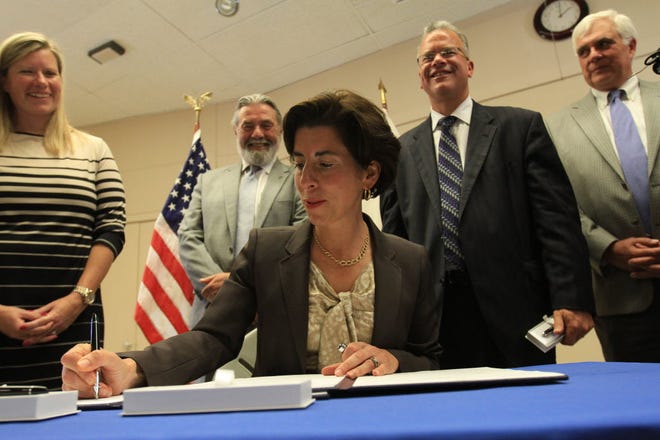 Governor Raimondo signs the minimum wage bill on June 22, 2015, at a ceremony at the United Food and Commercial Workers' union hall Local 328 in Providence. From left to right are, Sen. Erin P. Lynch, co-sponsor of the bill; Rep. David A. Bennett; House Speaker Nicholas A. Mattiello; and George Nee, president of the AFL-CIO in Rhode Island.