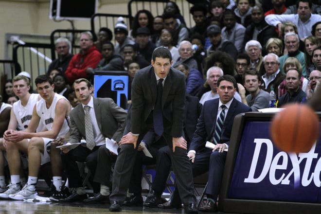 Coach Mike Martin and the Brown bench watch as Wednesday's night game against URI heads toward overtime.