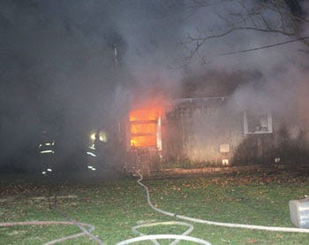 Firefighters from Constantine and White Pigeon battle a house fire at 13860 Riverside Drive Sunday night.
