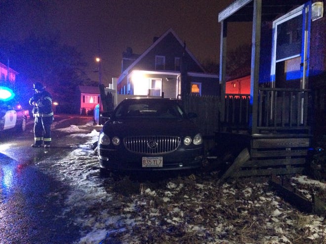 A car crashed through a fence and into a porch at a house at 33 Johnson Square Tuesday night Dec. 29, 2015.