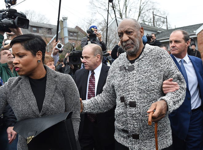 Bill Cosby is led to a waiting car from his arraignment for three counts of aggravated indecent assault flanked by attorneys Monique Pressley and Brian J. McMonagle on Wednesday, Dec. 30, 2015, at the office of District Judge Elizabeth McHugh in Elkins Park. Cosby was then taken to the Cheltenham Township Police Department for booking.