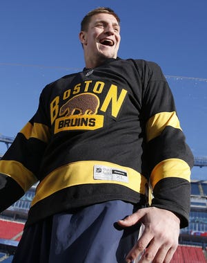 Patriots' tight end Rob Gronkowski was sporting a Boston Bruins jersey at Gillette Stadium Thursday, but his attention will be back on football for Sunday's game at Miami. MICHAEL DWYER/THE ASSOCIATED PRESS