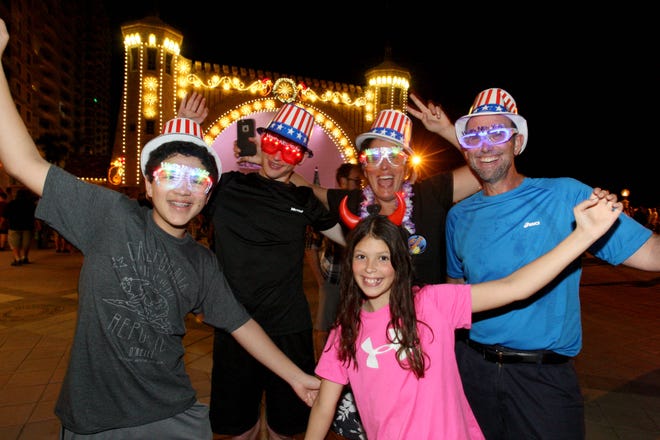 Matthew Levine, 13, from left; Ben Rose, 14; Grace Rose, 11; Shari Rose; and Patrick Rose, all from Michigan, enjoy New Year's Eve festivities and unusually warm weather as they ring in 2016 at the Daytona Bandshell. News-Journal/LOLA GOMEZ