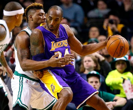 Los Angeles Lakers' Kobe Bryant moves on Boston Celtics' Marcus Smart during the second quarter of an NBA basketball game in Boston on Wednesday, Dec. 30, 2015. (AP Photo/Winslow Townson)