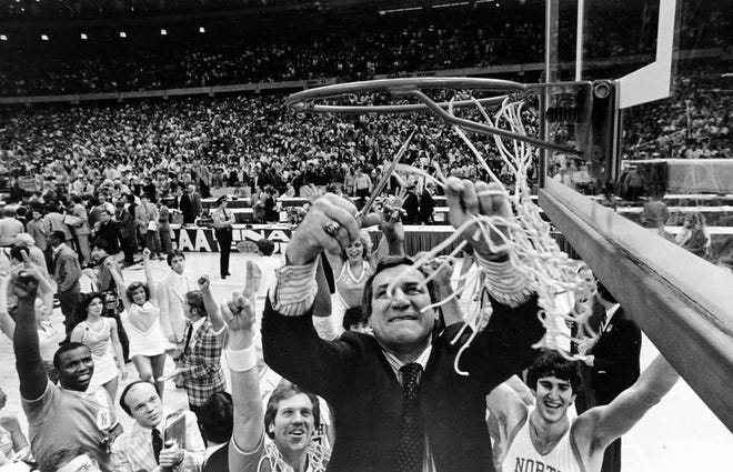 FILE - In this March 30, 1982, file photo, North Carolina coach Dean Smith cuts down the net at the Superdome in New Orleans, after his Tar Heels defeated the Georgetown Hoyas 63-62 to win the NCAA college men's basketball championship. Smith, the North Carolina basketball coaching great who won two national championships, died "peacefully" at his home Saturday night, Feb. 7, 2015. He was 83. (AP Photo/File)