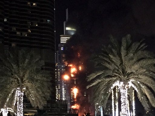 A fire runs up some 20 stories of a building in Dubai, United Arab Emirates, on Thursday, Dec. 31. The fire broke out Thursday in a residential building near Dubai's massive New Year's Eve fireworks display. It was not immediately clear what caused the fire near the Burj Khalifa, the world's tallest skyscraper at 905 yards.