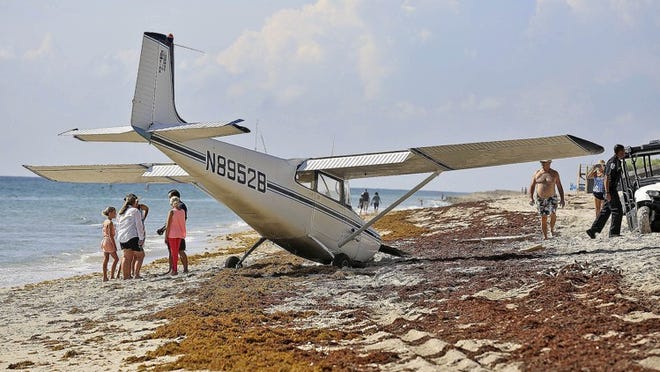 A Cessna crash-landed propeller-first into the beach at Singer Island on Aug. 22. A federal report hints that engine problems may have been caused by a buildup of ice that could have been prevented. (Bill Ingram / Palm Beach Post)