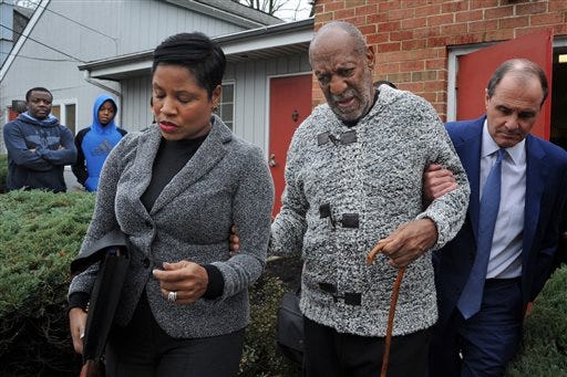 Actor and comedian Bill Cosby is helped as he leaves after a court appearance, Wednesday in Elkins Park, Pa. Cosby was arrested and charged with drugging and sexually assaulting a woman at his home in January 2004.