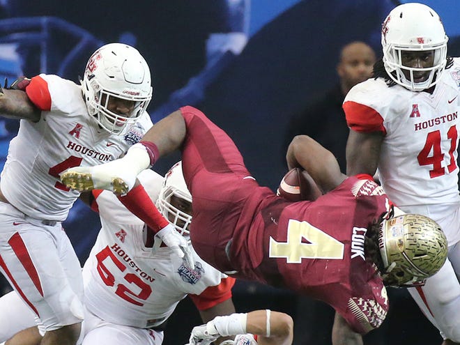 Houston defenders cut down Florida State running back Dalvin Cook for a short gain during the second half of the Peach Bowl football game, Thursday, Dec. 31, 2015, in Atlanta.