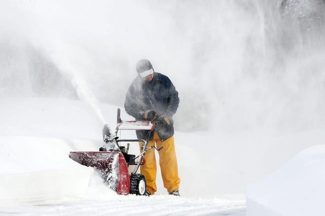 Ralph DeMent has to pause as the snow he is trying to clear from his Cobleigh Road driveway in Boxborough blows back in his face. Wicked Local Staff Photo/Ann Ringwood