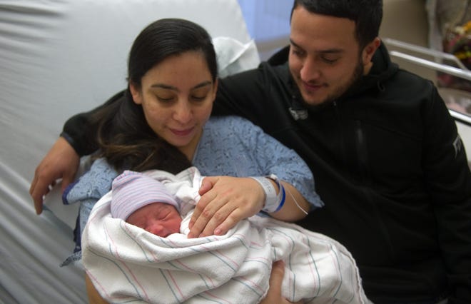 Denise Andrade and Armando Valencia of Stockton hold 5-pound, 14-ounce newborn Alyssa Valencia, San Joaquin County's first baby born of 2016. Alyssa was born at 1:19 a.m. New Year's Day at Stockton's Dameron Hospital, about two weeks earlier than her parents were expecting. CLIFFORD OTO/THE RECORD
