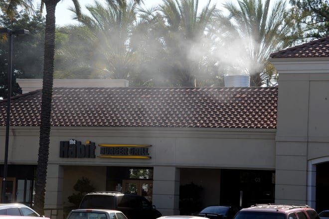 Smoke bellows out an exhaust pipe from The Habit, a hamburger restaurant on west March Lane in Stockton.  CALIXTRO ROMIAS/THE RECORD