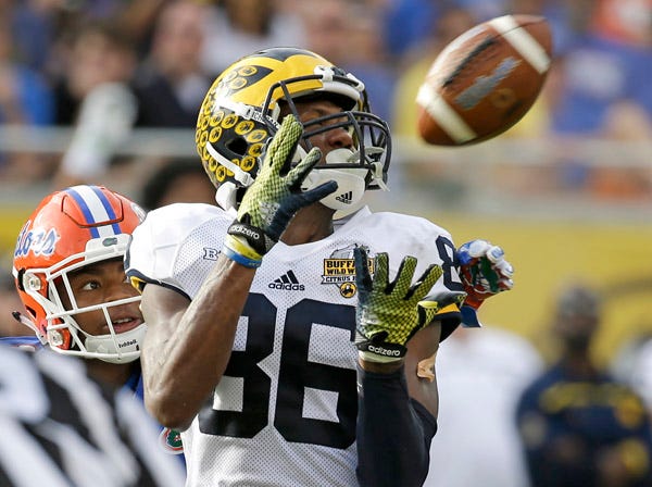 Michigan’s Jehu Chesson catches a pass against Florida’s Vernon Hargreaves III during Friday’ Citrus Bowl game. (John Raoux | Associated Press)