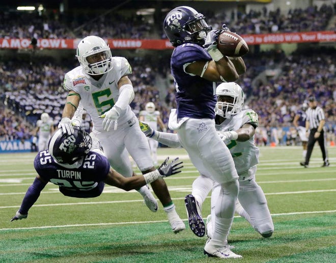 TCU wide receiver Jaelan Austin (15) catches a touchdown pass in front of Oregon cornerback Chris Seisay (12) during the second half of the Alamo Bowl NCAA college football game, Saturday, Jan. 2, 2016, in San Antonio. (AP Photo/Austin Gay)